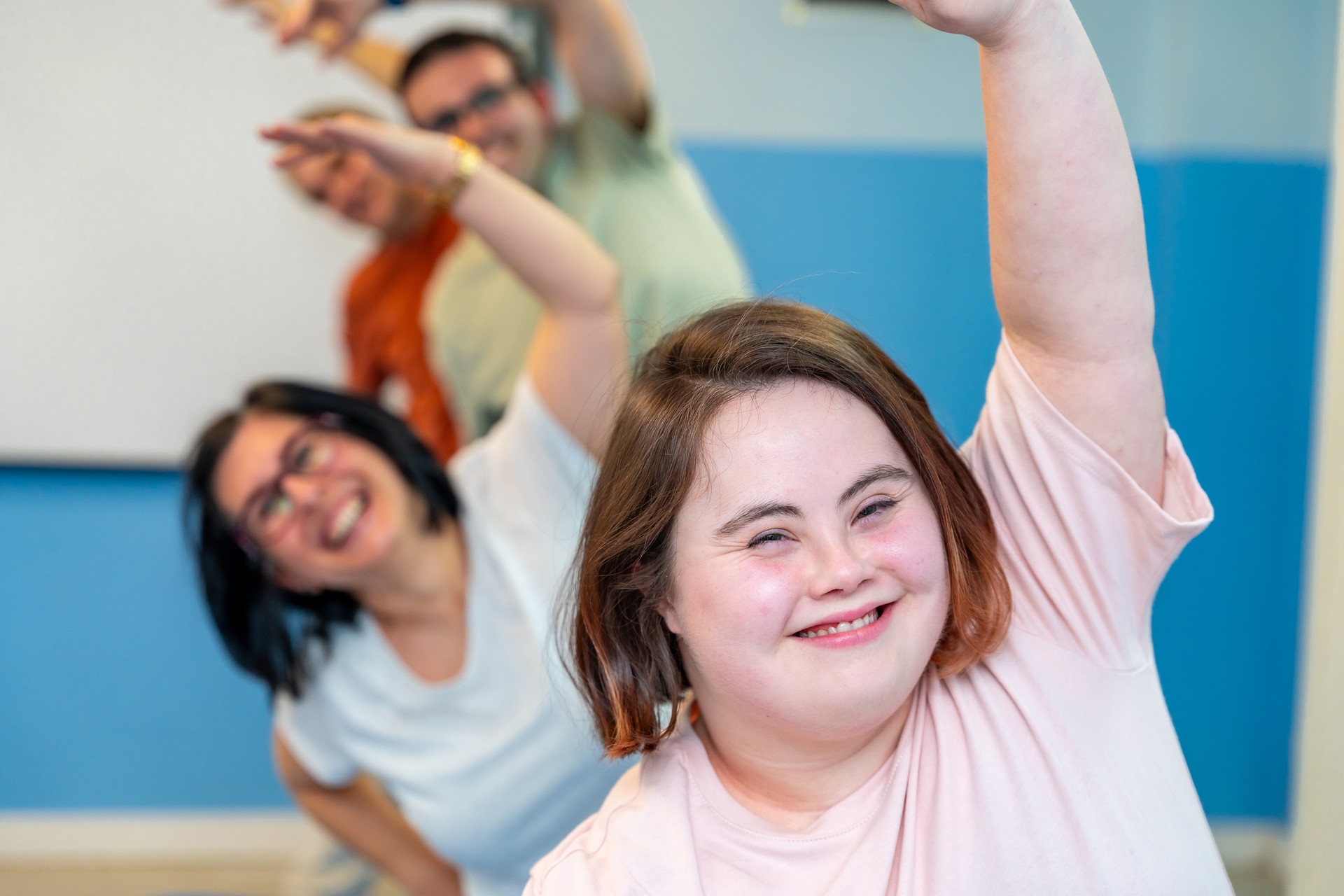 Happy group of people with special needs enjoying gymnastics